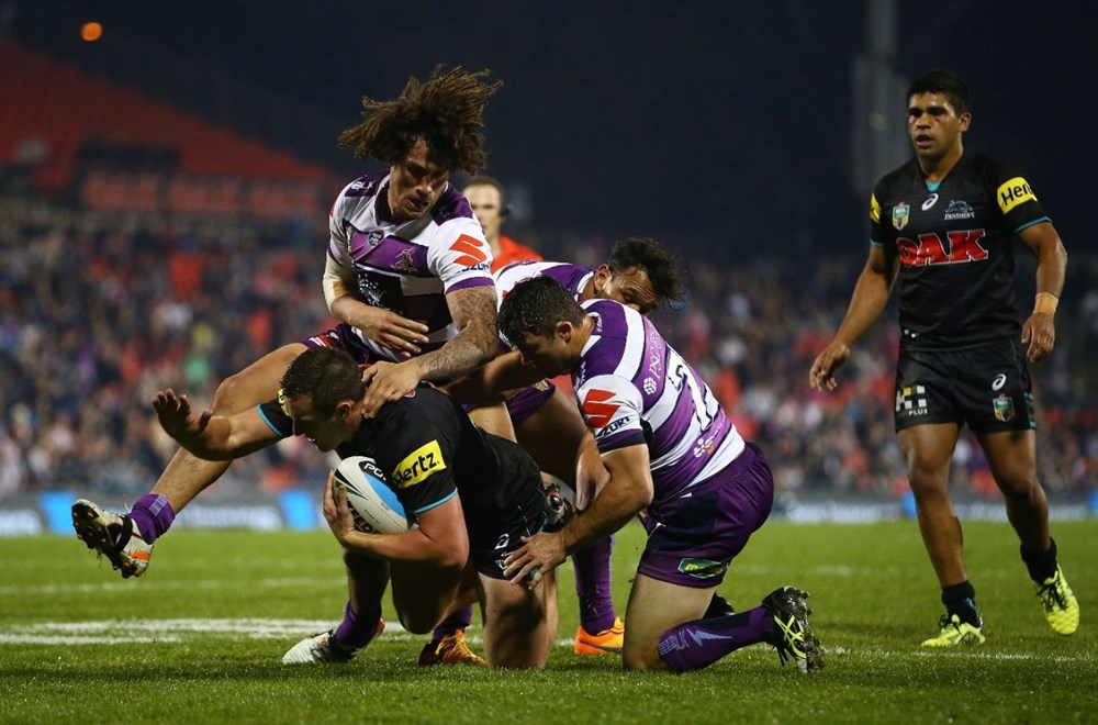 Kevin Proctor of the Storm tackles Isaah Yeo of the Panthers during the round 13 NRL match between the Penrith Panthers and the Melbourne Storm at Pepper Stadium on June 6, 2015 in Penrith, Australia. Digital Image by Mark Nolan.
