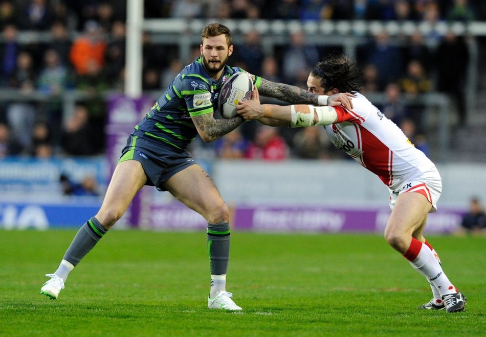 Zak Hardaker is held by Louie McCarthy-Scarsbrook.St Helens v Leeds Rhinos.  First Utility Super League.  Langtree Park.  22 April 2015.  Picture Bruce Rollinson